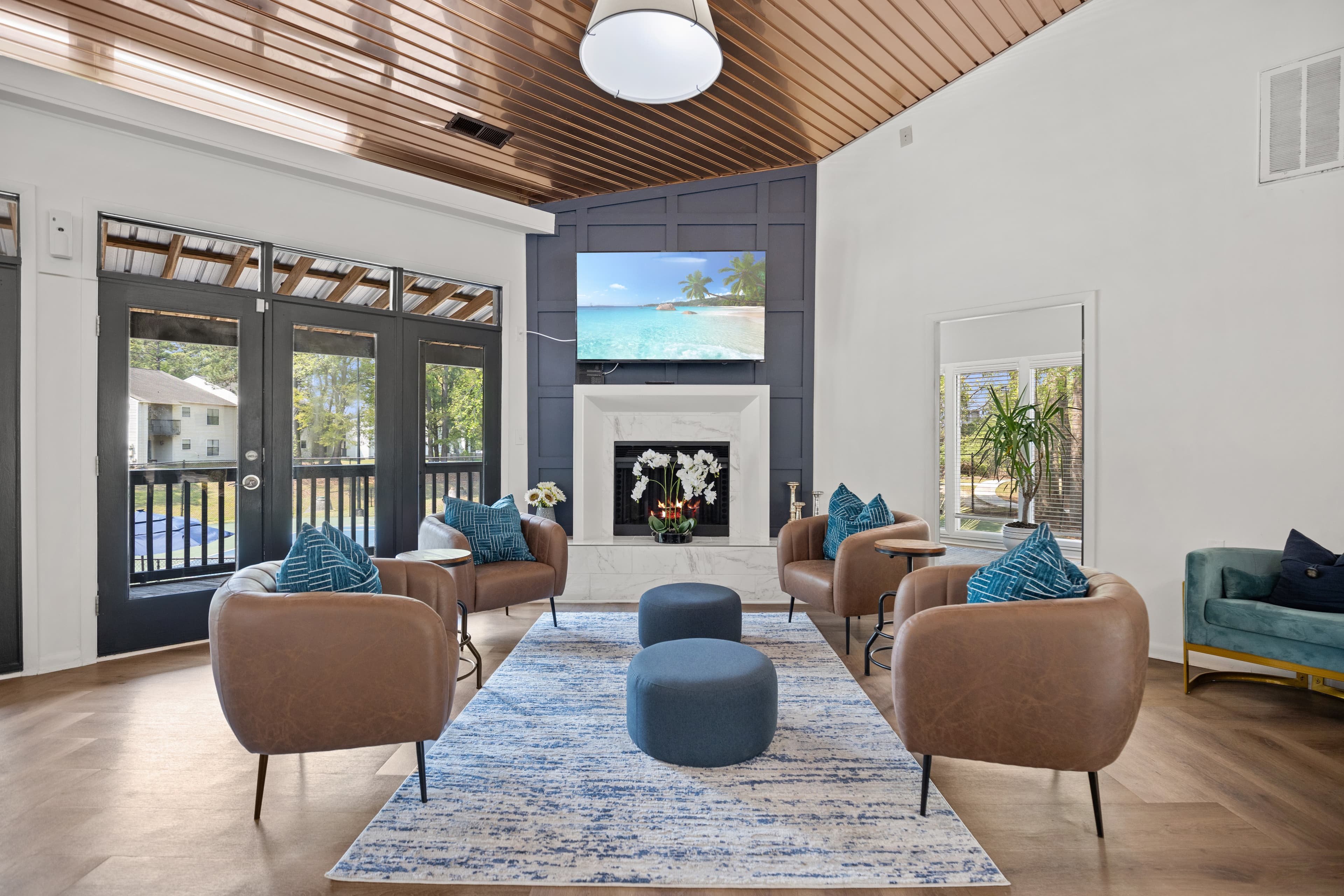 A living room with a fireplace and a view of the ocean.